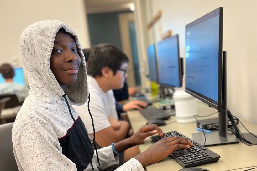 Students do hands-on computer activities related to cybersecurity.