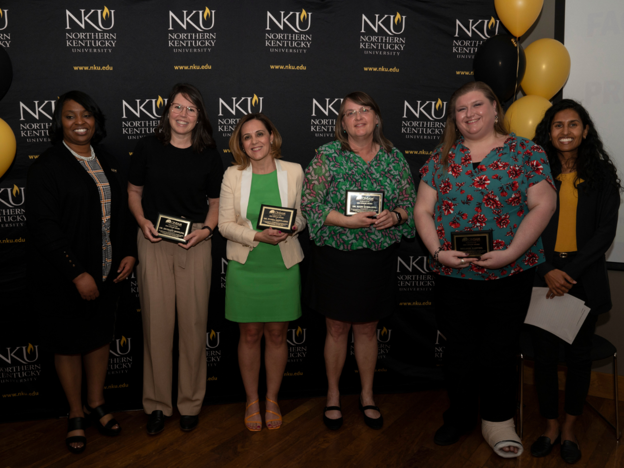 CINSAM Award winners pose for a picture with their plaques