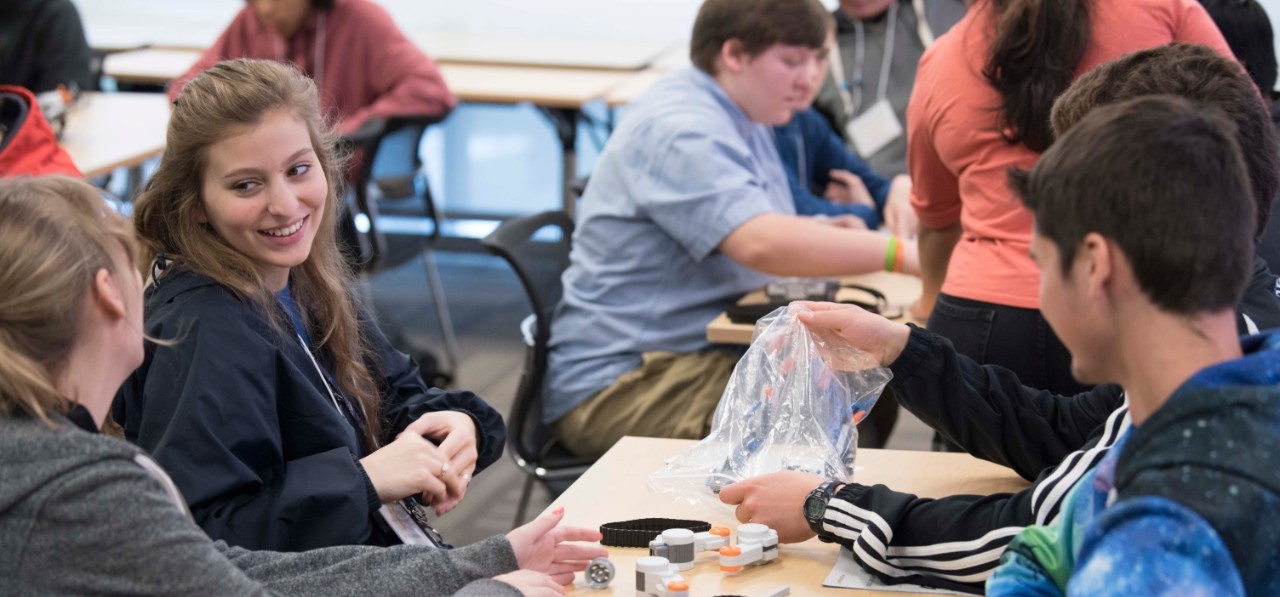 High school students enjoy an engaging STEM activity together at High School STEM+H Day