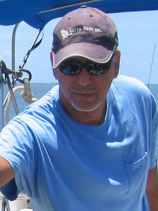 Dr. Charles Acosta at sea on a boat during research.