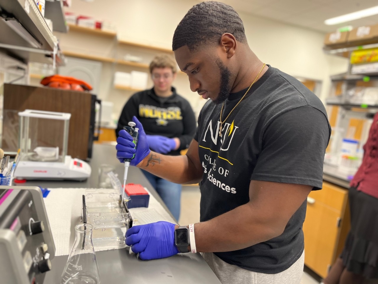 Biology students work on laboratory research together.