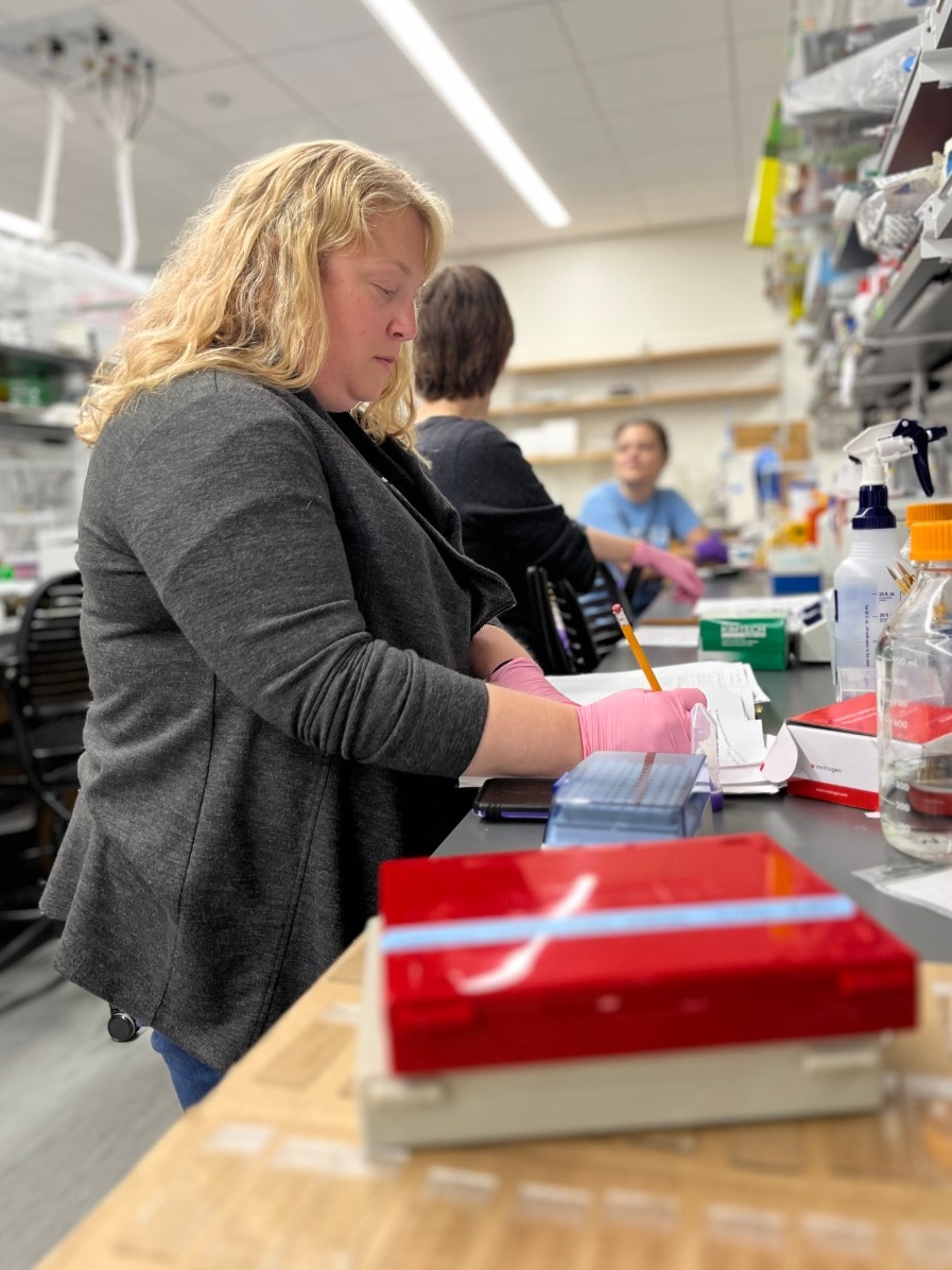 Dr. Williamson conducts research in the lab with students.