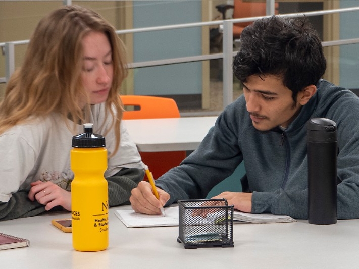 A student tutors another student in math subjects.