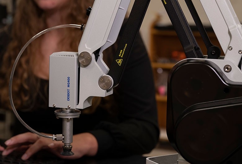 Student in a lab using electronics.