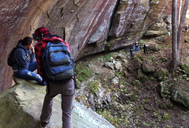 Geology students hiking and exploring caves.