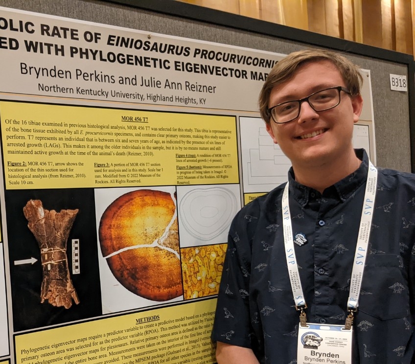 Brynden Perkins smiling next to his research poster.