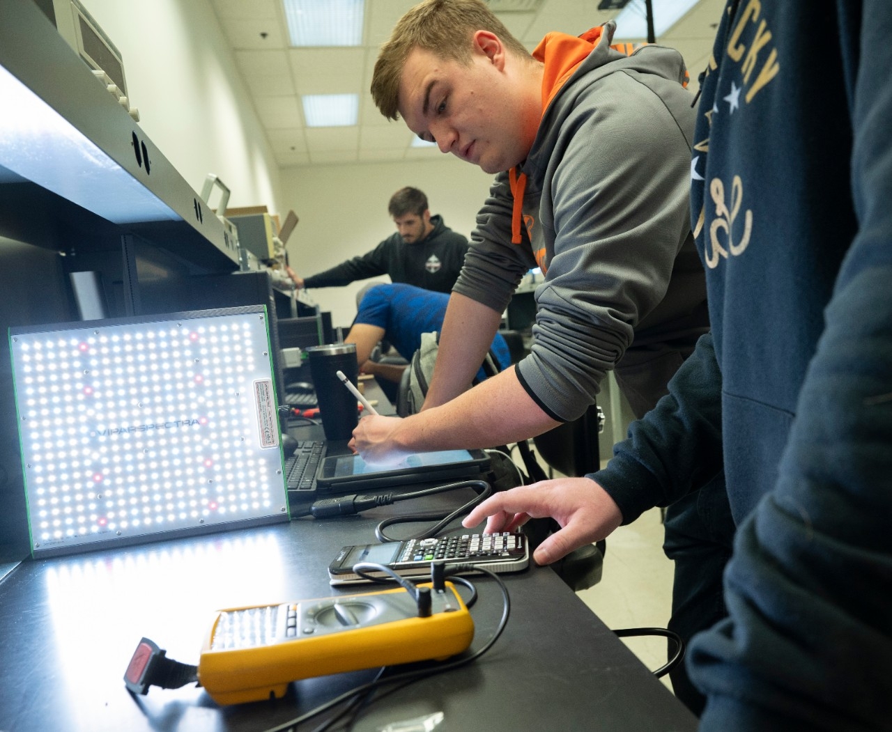 Engineering students practicing with electronics in a laboratory