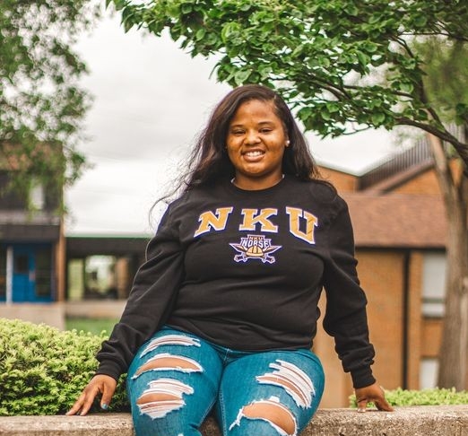 India standing on campus with NKU sweatshirt on