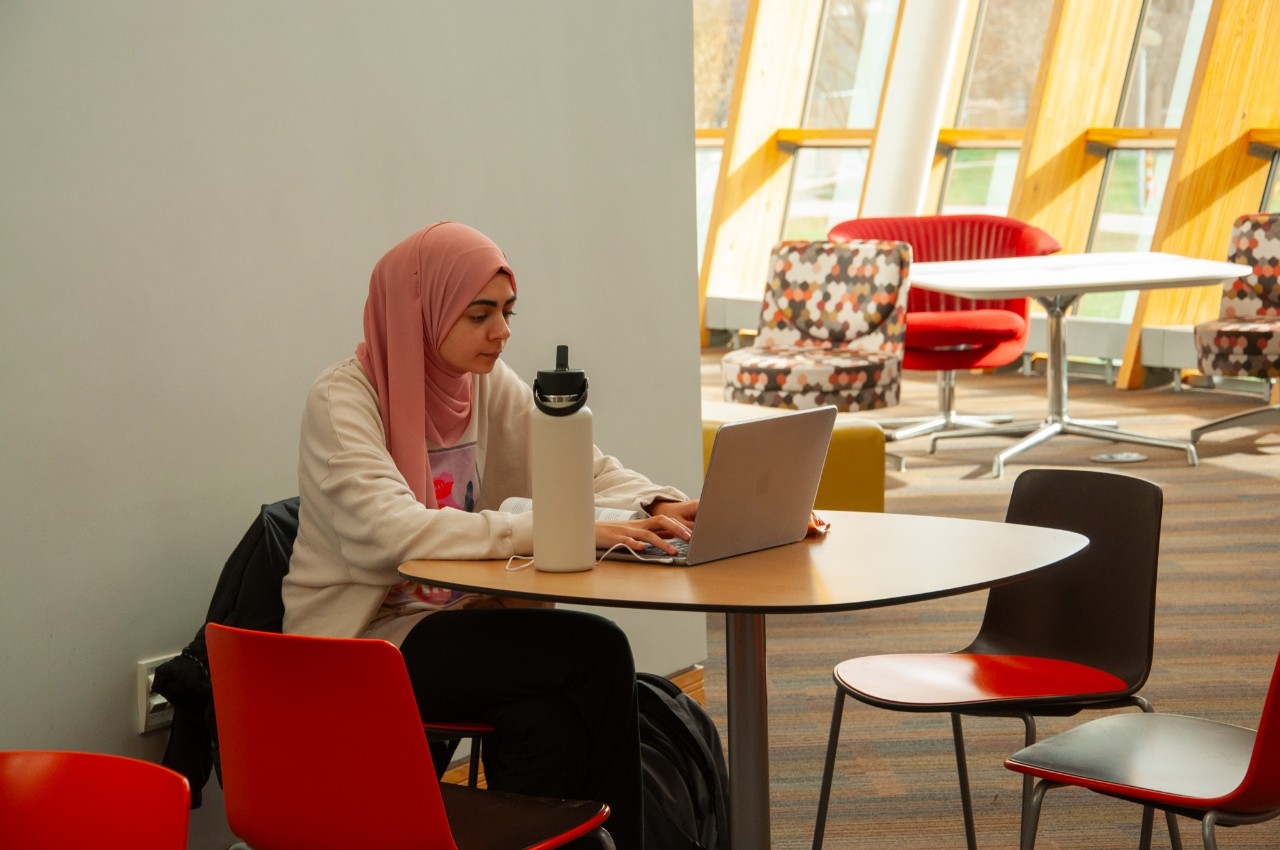 Female student working on her laptop in Griffin Hall