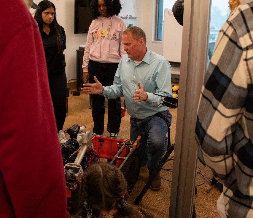 Man giving a demonstration with equipment 