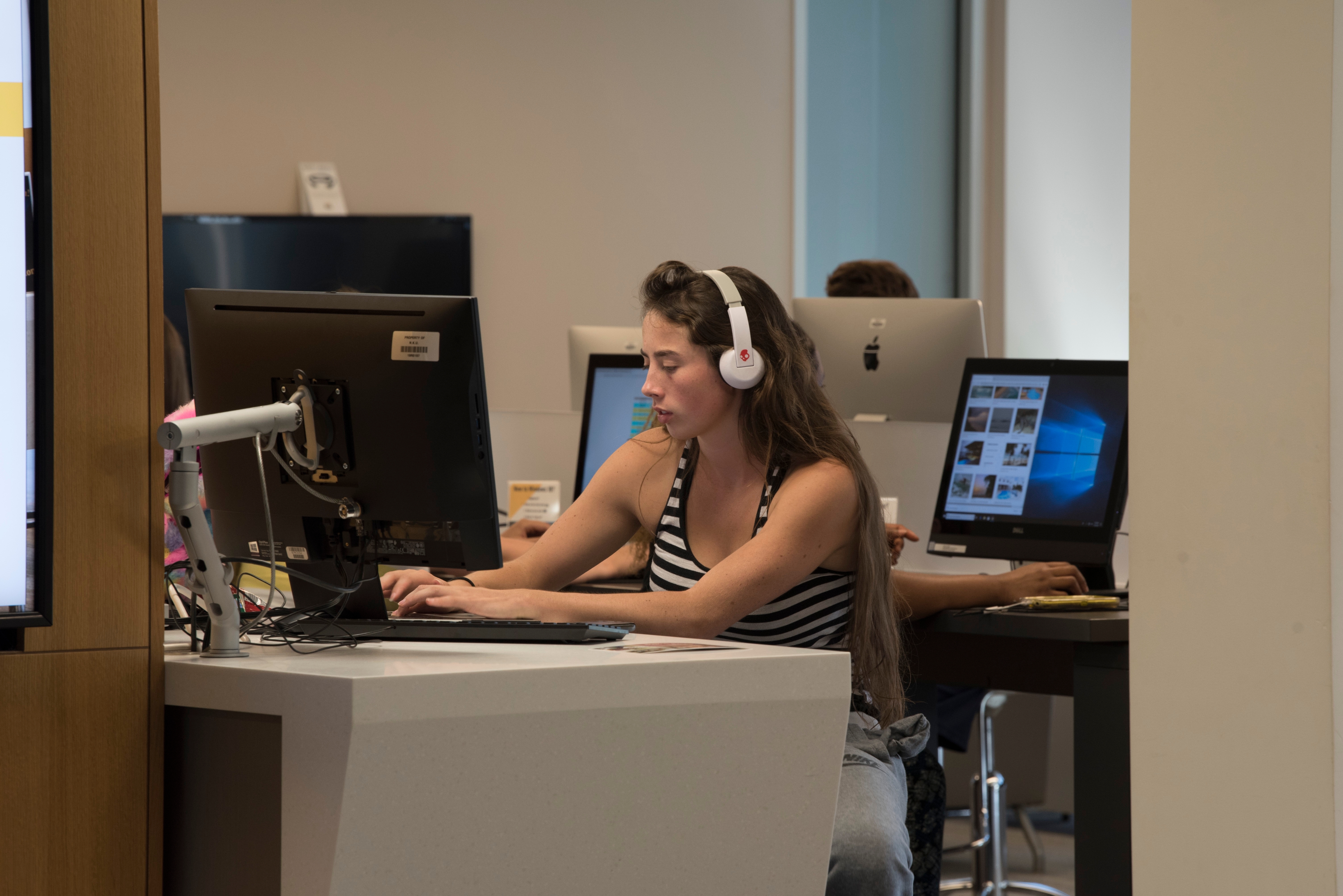 Woman in library working on a laptop