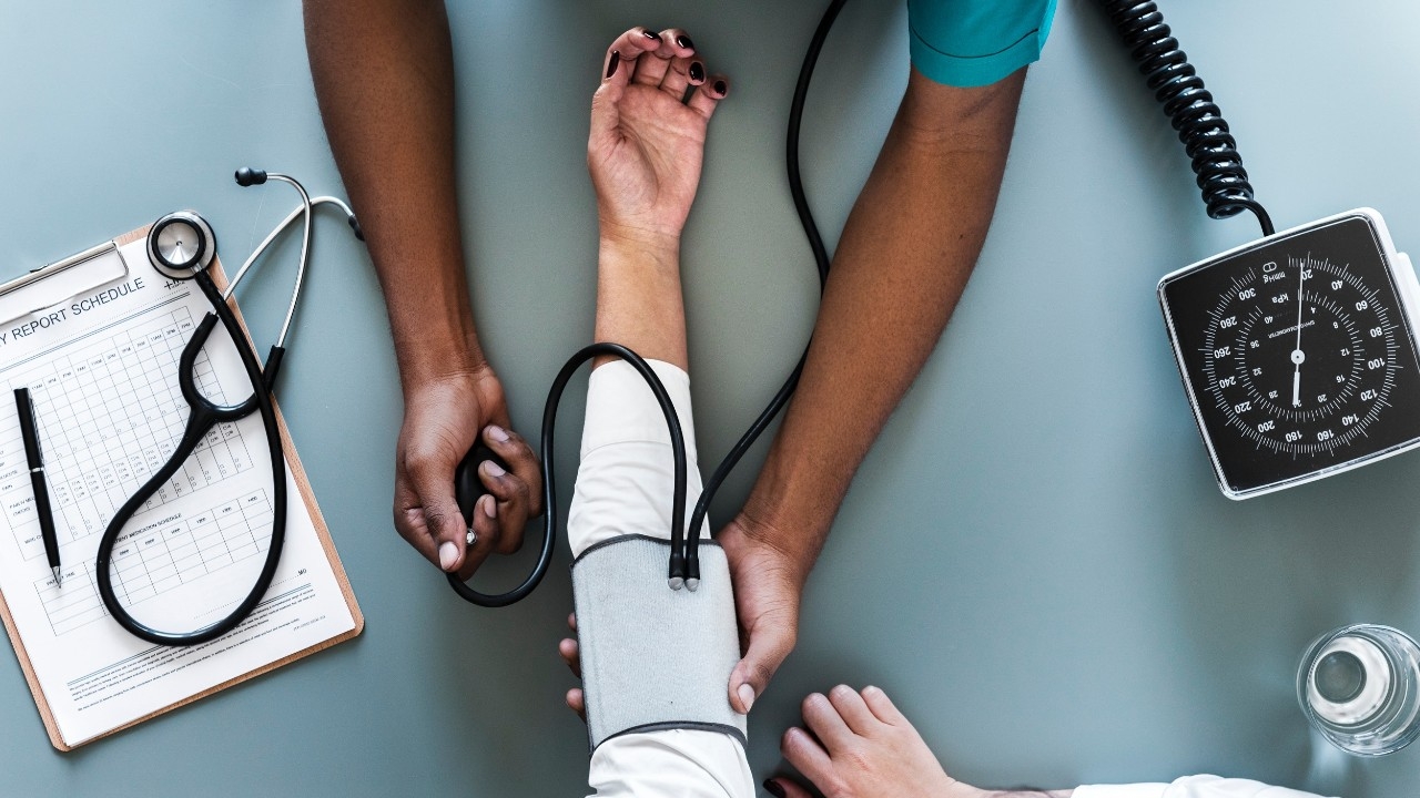 nursing student taking blood pressure reading