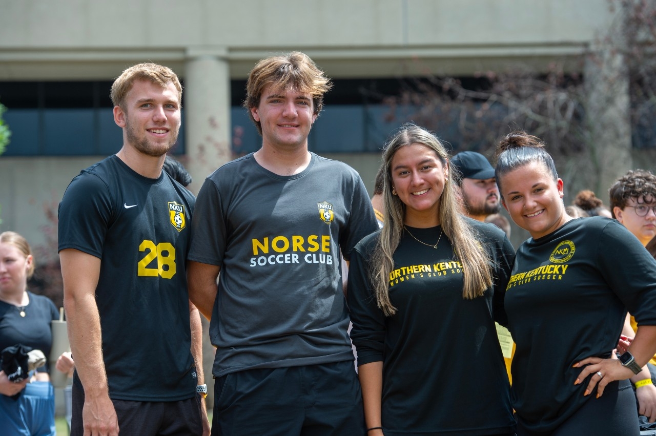 Four NKU soccer clumb students posing next to each other.