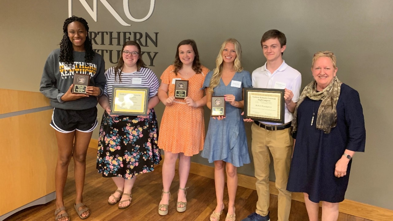 Students holding their scholarship awards