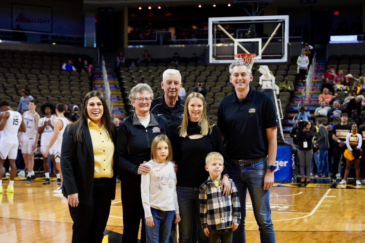 Jane Meier stands with her family and Athletics Director Christina Roybal during a ceremony before a Norse men's basketball game on Saturday, January 11th. 